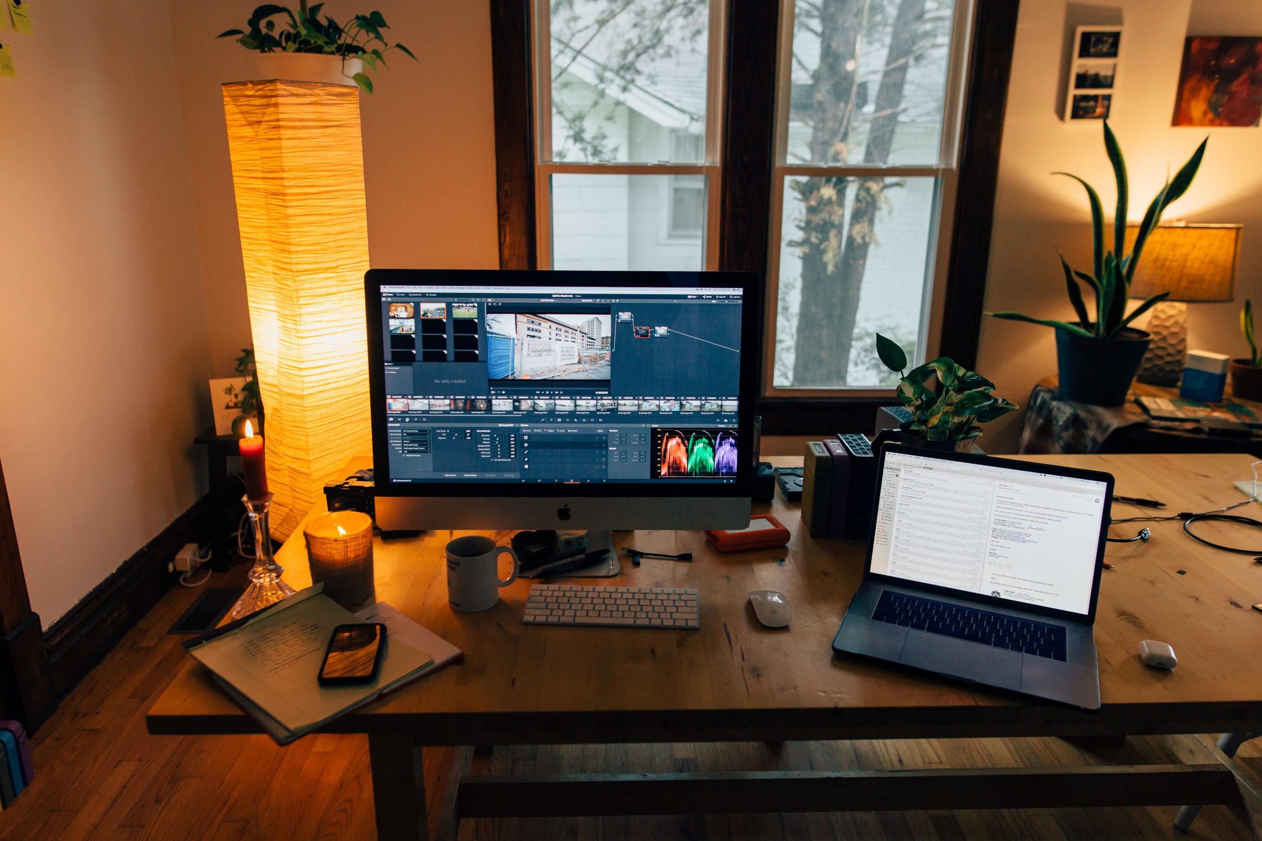 a desk with an apple computer and a laptop on it